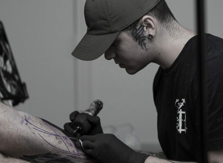 Image of Ricardo Vega passionately tattooing, creating exceptional art with precision and skill.