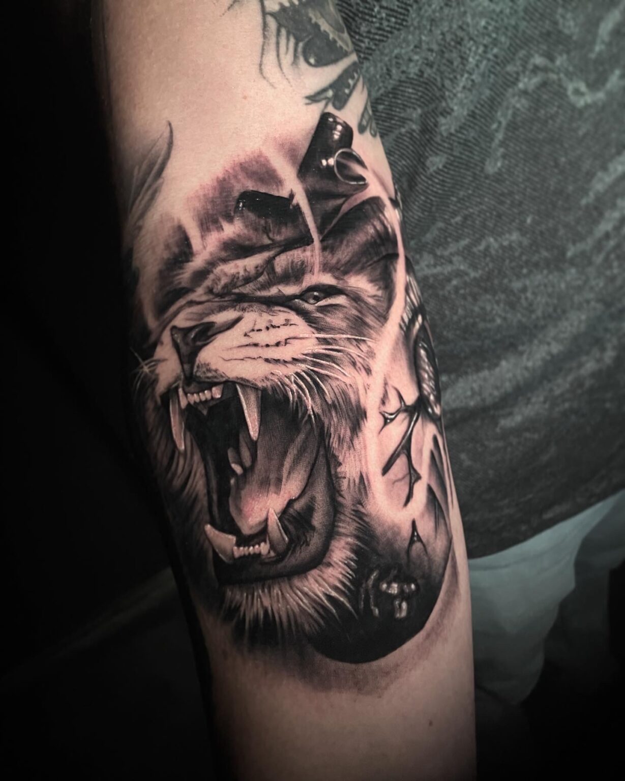 Striking heart and lion morphed tattoo, a captivating fusion of power and love. This unique design seamlessly blends the elements of a lion and a heart, symbolizing strength, courage, and passion.